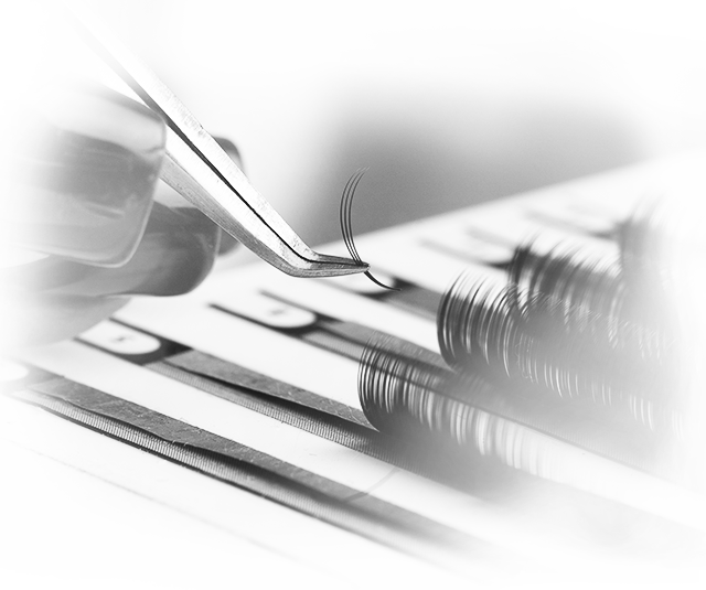 Imagen gris de las pinzas sujetando las pestañas.